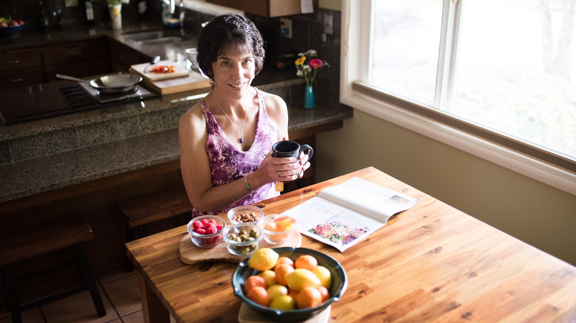 Ellen at table with drink and fruit